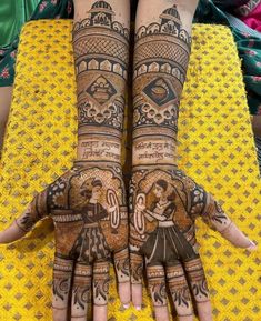 two hands with henna designs on them