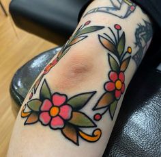 a woman's arm with flowers on it