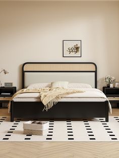 a bed sitting on top of a wooden floor next to a white and black rug