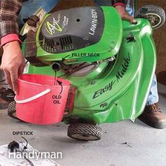 a man is using a green lawn mower