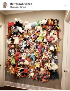 a bunch of stuffed animals are hanging on the wall in front of a closet door