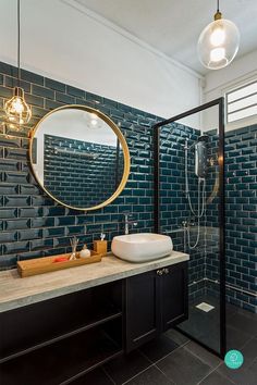 a bathroom with a sink, mirror and shower stall in it's own area