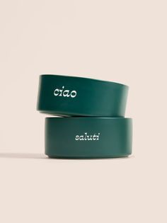 two green bracelets with the word otao written on them in white lettering, sitting next to each other