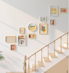 there are many framed pictures on the wall next to the bannister and stairs