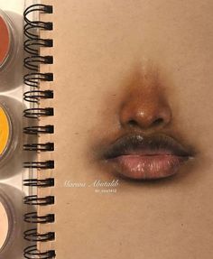 an open spiral notebook with three different colors of makeup on it and the bottom one is drawn