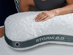 a woman laying on an osmots mattress with her arm resting on the pillow