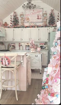 a pink christmas tree sitting in the corner of a kitchen