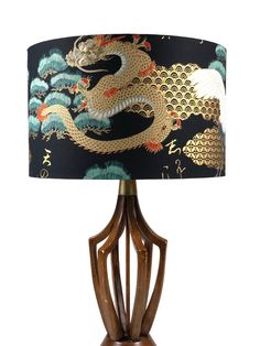 a wooden table lamp with a dragon on it