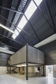 the inside of an industrial building with metal roofing and large open area for seating