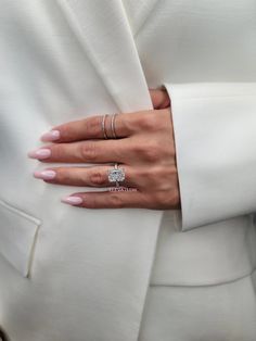 a close up of a person's hand wearing a ring