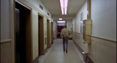 a person walking down a long hallway