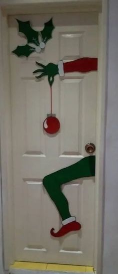 the door is decorated to look like elf legs and feet with christmas decorations on them