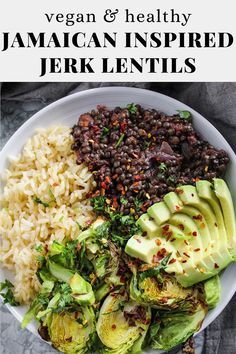 a bowl filled with rice, beans and avocado on top of a table