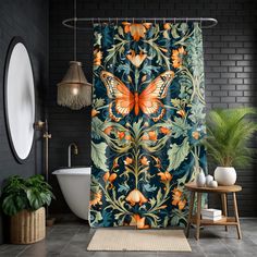 a shower curtain with an orange butterfly on blue and green floral design, next to a white bathtub