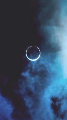 an eclipse is seen in the sky with clouds and blue hues on its surface