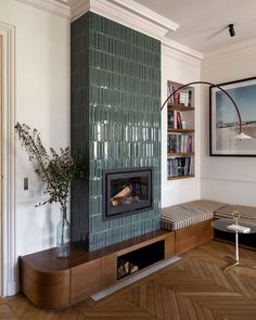 a living room with a fireplace and bookshelf