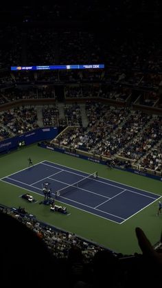 a tennis match is being played at night