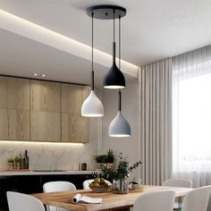 a dining room table with chairs and lights hanging from it's ceiling above it