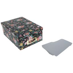 a black and pink flowered box next to a silver square object on a white background