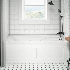 a white bathroom with black and white tile flooring is featured in the magazine made in usa