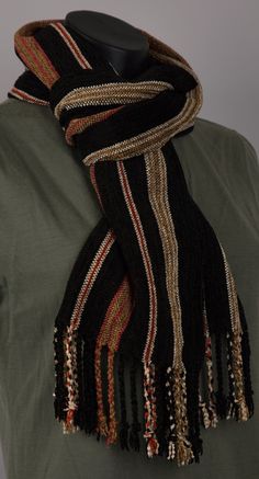 This scarf has a velvety luxurious feel against the skin. There are stripes of black alternating with cream and beige with orange as an accent. This scarf drapes beautifully. I have woven this scarf in a plain weave because the feature of this scarf is the yarn and the rich colours.  *Yarn type : Rayon Chenille / Tencel *Colour : Black, Cream, Beige, orange *Size: 69″ x 9" (175 x 23 cm), excluding the twisted fringe *Fringe : Yes, 3″ (7.5 cm) *Care : Dryclean Only Chenille is created by putting short lengths of yarn between two core yarns and twisting them together. This process forms loops which are then cut and this gives the classic fuzzy velvety feel of chenille. The yarn I used in this scarf as the warp was rayon chenille. Rayon is produced from natural sources which have been regener Chenille Scarf, Scarf Yarn, Cellulose Fiber, Cream Beige, Plain Weave, Black Cream, Rich Color, Scarf Wrap, New Style