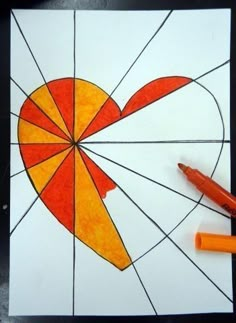 two markers are next to a piece of art that looks like a heart with an arrow on it