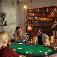 three people sitting at a table with cards and wine glasses in front of the table