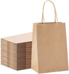 a stack of brown paper bags sitting next to each other on top of a white surface