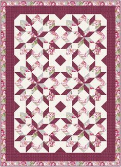 a pink and white quilt with flowers on it