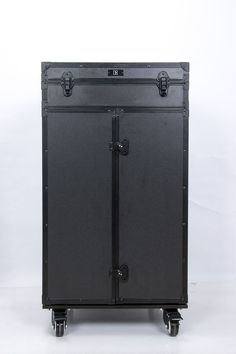 a large black case sitting on top of a white floor next to a pair of handles