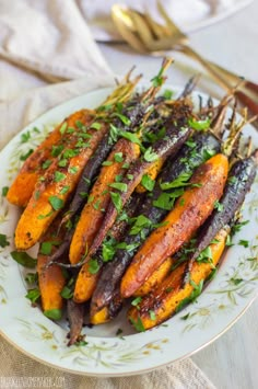 grilled carrots with herbs on a white plate