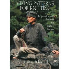 the book viking patterns for knitting is on display in front of some rocks and trees