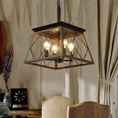 a chandelier hanging from the ceiling in a dining room