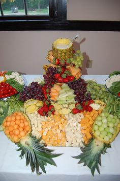 a table topped with lots of different types of fruits and veggies on top of it