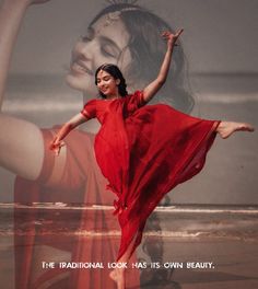 a woman in a red dress is dancing on the beach