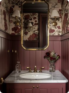 a bathroom sink sitting under a large mirror next to a wall mounted faucet