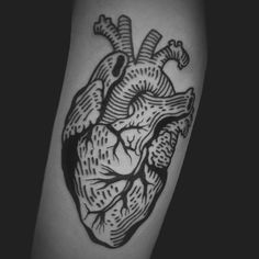 a black and white photo of a heart tattoo