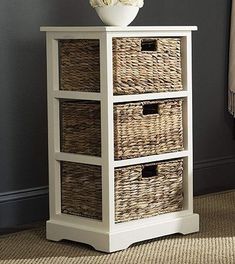 a white vase sitting on top of a wicker chest