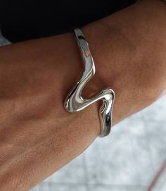 Sterling Silver Wave Bracelet, Open Cuff Bracelet, Bracelet for Women, Chunky Silver Bracelet, Modern Bracelet, Geometric Bracelet Although made from thick silver there is a certain amount of give in the bangle allowing you to adjust it by carefully squeezing the ends together or pulling open slightly. To determine your size, please measure the circumference of your wrist with a tape measure or piece of paper. The cuff has a slight flexibility to allow you to fit it to your own wrist once it is Timeless Silver Bracelet, Luxury Modern Cuff Sterling Silver Bracelet, Chunky Silver Bangle, Chunky Silver Bracelets, Unique Silver Bracelets, Silver Jewelry Chunky, Layering Bracelets Silver, Chunky Silver Jewelry, Edgy Silver Jewelry