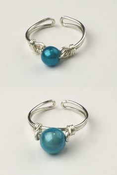 two silver rings with blue beads on them