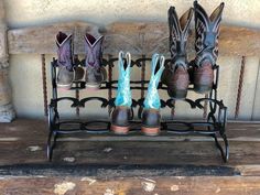 four pairs of boots are sitting on a rack