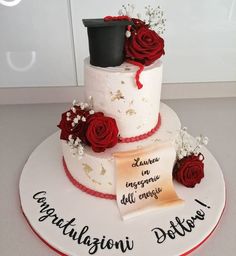 a three tiered cake with red roses on top and congratulations written on the side