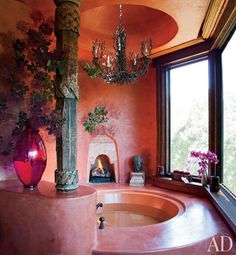 a bath room with a large tub and a chandelier