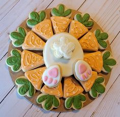 decorated cookies arranged in the shape of an animal's paw on a wooden platter