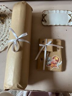 two wrapped presents sitting next to each other on a table