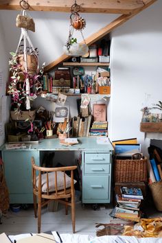 an old desk with lots of books and other items on it in the corner of a room