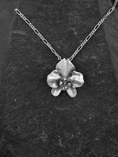 "This solid 3 Dimensional Original Phalanopsis Orchid is Sterling Silver, The included chain is a Sterling Silver Figaro 50 chain. You may chose 16, 18 or 20 inch at the same price. Other length available at sightly higher prices. The Orchid pendant measures 1' tall by by 7/8\" across. I hand cast all my pieces using the lost wax casting method. Please ask your needs. You may call me with questions, often I am out so please use my machine. 831-476-3176. Satisfaction Guaranteed! I send items USPS Orchid Pendant, Orchid Necklace, Lost Things, Dinosaur Pendant, Lightning Bolt Earrings, The Orchid, Silver Heart Earrings, Spring Accessories, Wax Casting