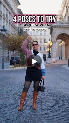 a woman standing in the middle of a cobblestone road with her hand up