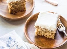 two plates with slices of cake on them and one plate has a fork in it