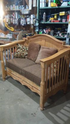 a wooden day bed in a store with lots of items on the shelves behind it